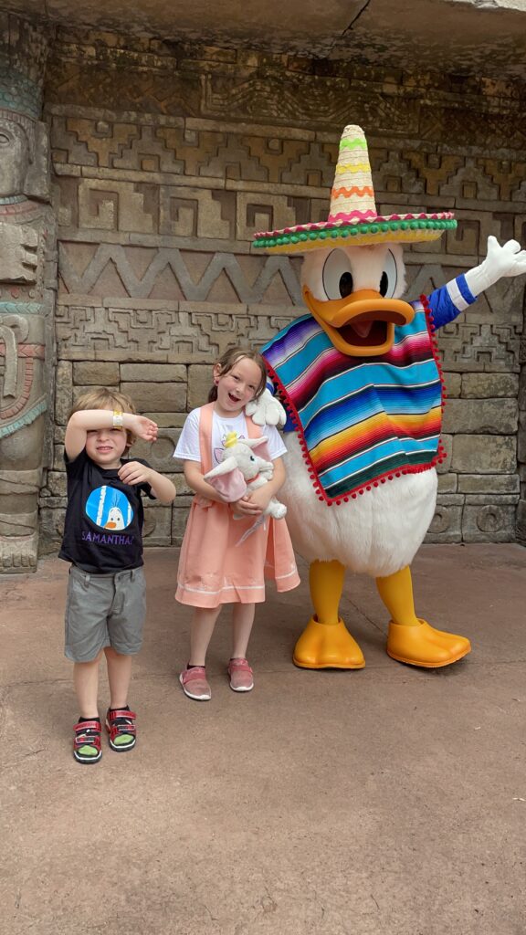 Our son and daughter stand next to Donald Duck in the Mexico pavilion.